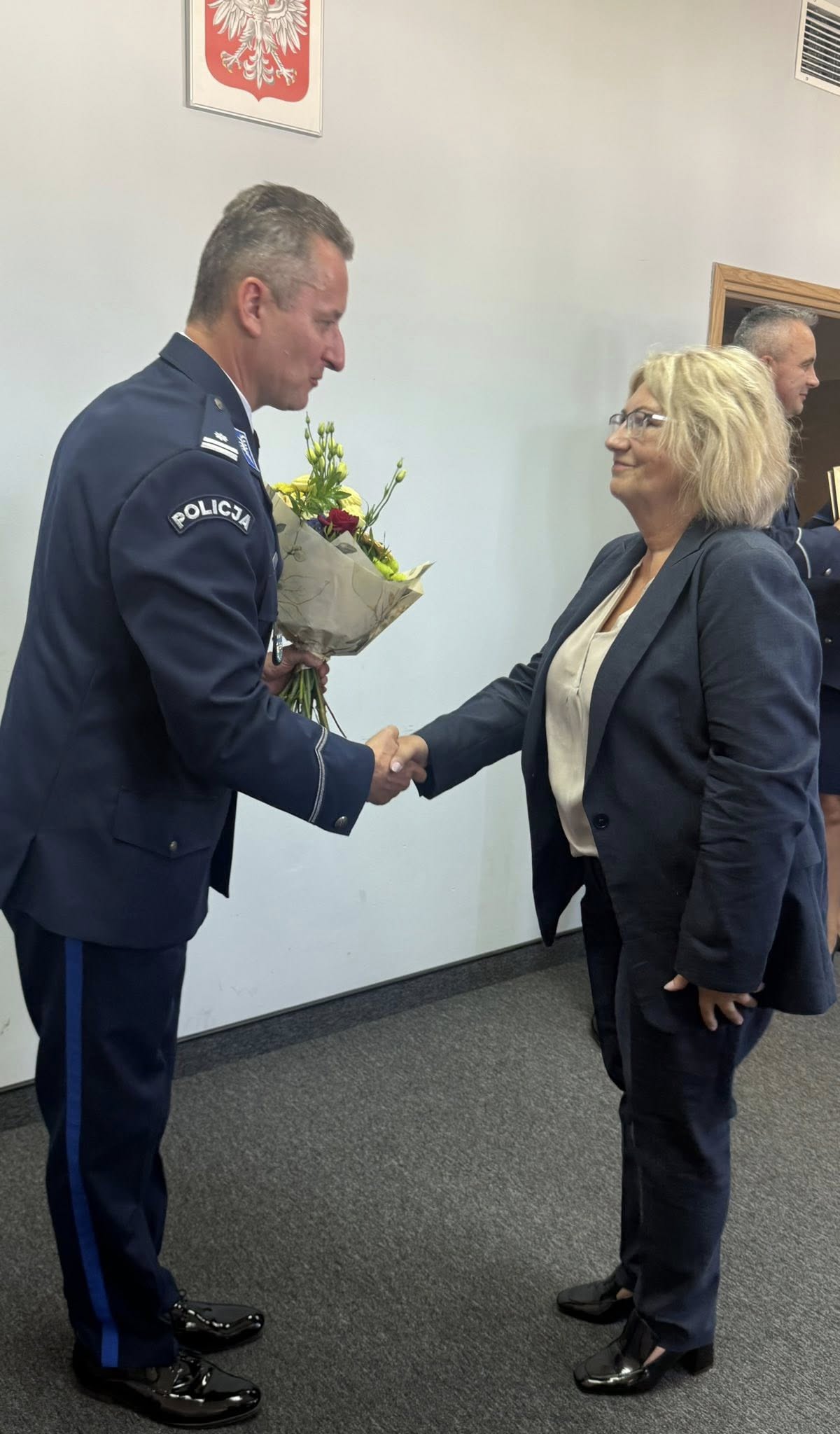 Kobieta składająca gratulacje policjantowi